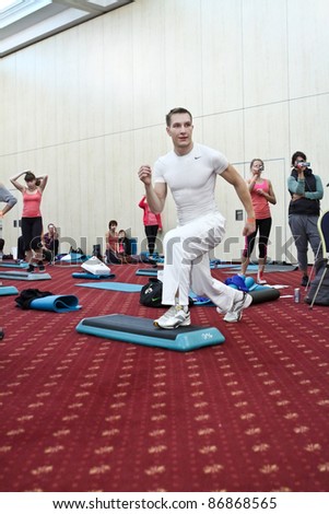 MOSCOW - OCTOBER 5: Man is doing a step aerobic move at the international exhibition of the fitness and wellness industry, MIOFF on October 5, 2011 in Moscow