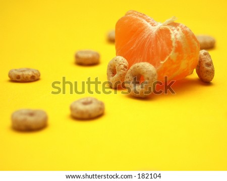 A car made out of a orange cereal on a yellow background