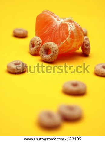 A car made out of a orange and cereal on a yellow background
