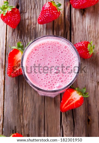 Fresh milk, strawberry drink on wodeen table, assorted protein cocktail with fresh fruits.