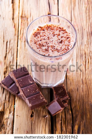 Fresh milk, chocolate drink on wodeen table, assorted protein cocktail.