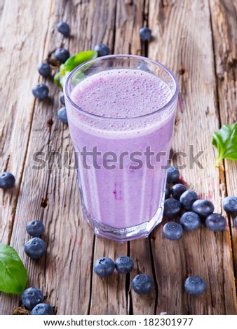 Fresh milk, blueberry drink on wodeen table, assorted protein cocktail with fresh fruits.