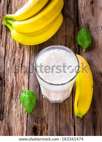 Fresh milk, banana drink on wodeen table, assorted protein cocktail with fruits.