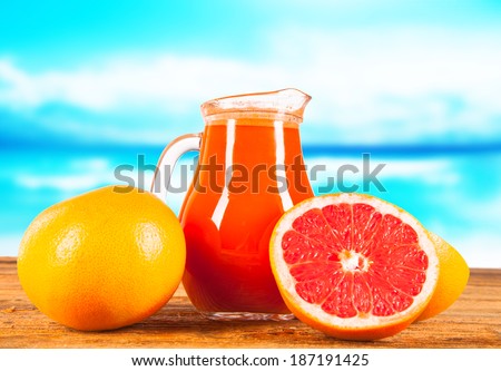 Fresh three juice, orange, strawberry and carrot drink on wooden background with blue sky. Summer concept.