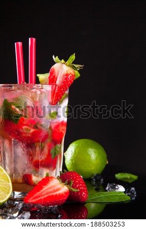 Summer strawberry cocktail , drink with fresh fruits on black stone.
