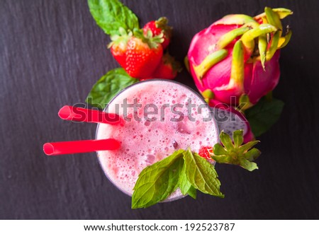 Summer, strawberry drink on black stone, table.