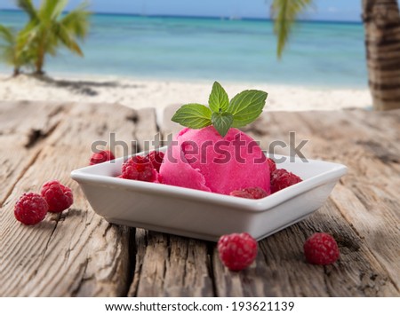 Ice Cream strawberry , summer sundae with fresh fruits on wooden background. Tropical beach.