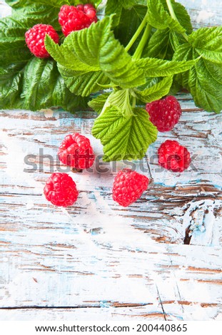 Heap of raspberry on wooden table. Fresh bio fruits.