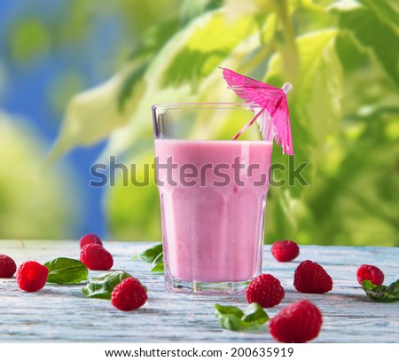 Fresh milk, raspberry drink on wooden table, assorted protein cocktails with fresh fruits. Natural background.