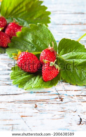 Strawberry on a white wood background. Fresh bio fruits on wooden table.