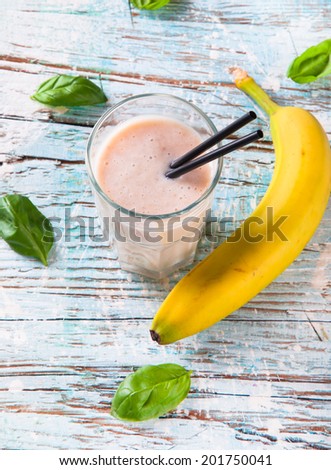 Fresh milk, banana drink on wooden table, assorted protein cocktails with fresh fruits.