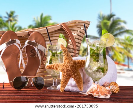 Summer concept, sandy, tropical beach,sandals and summer drink