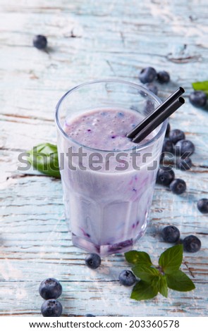 Fresh milk, blueberry drink on wooden table, assorted protein cocktails with fresh fruits. Natural background.