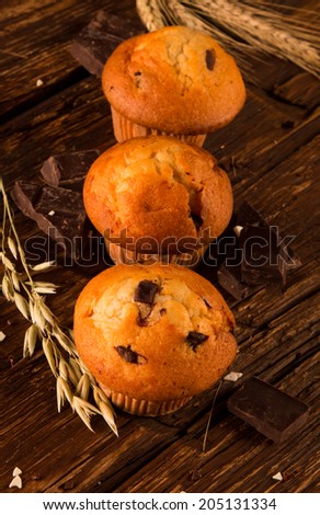 fresh muffins on wooden table and corn