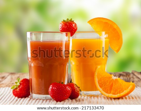 Fresh juice, mix fruits, strawberry and orange drinks with nature green background