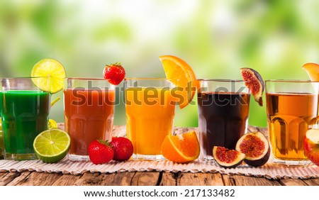 Fresh juice, mix fruits orange, strawberry, lime, apple and ficus drinks with nature background.