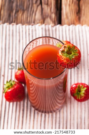 Fresh strawberry drink on wood background, juice drink