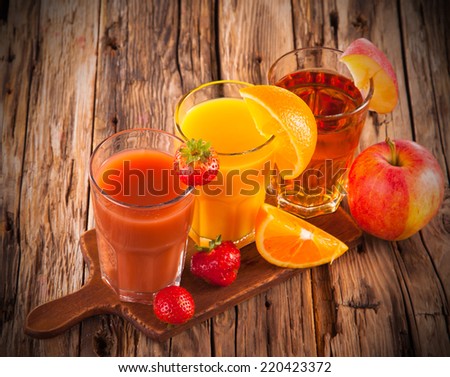 Fresh fruits juices on wood plant, strawberry, orange and apple drinks