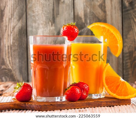 Fresh juice, mix fruits, strawberry and orange drinks on wood plants