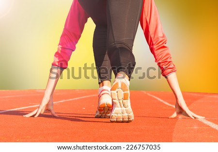 Runner feet running on running track closeup on shoe