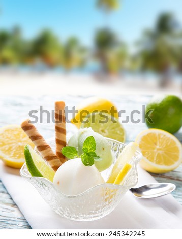 Ice Cream lime, summer sundae with fresh fruits on wooden background.