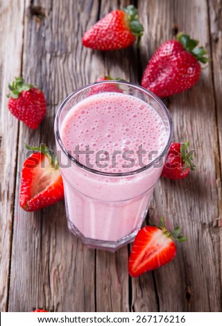 Fresh milk, strawberry drink on wooden table, assorted protein cocktail with fresh fruits.