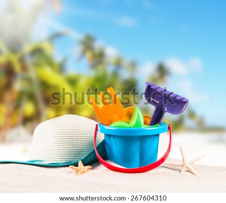 flip-flops, sand cake children  with tropical beach background, summer accessories