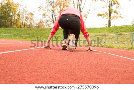 Runner feet running on running track closeup on shoe