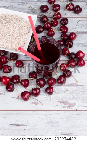 sweet cherries juice on wooden table, fresh drink, summer concept