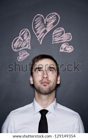 young man and chalk drawn hearts, blackboard wall