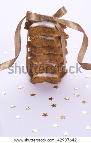 cookies with decorative gold ribbon and stars on white background