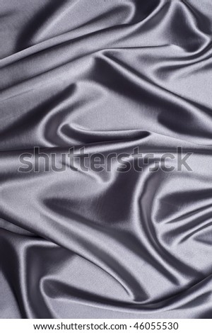 textile silver silk background draped in waves