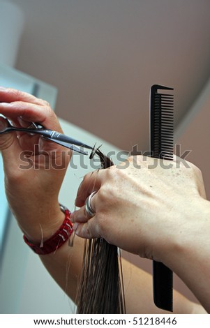 hair dresser is cutting hair