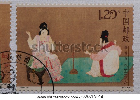 CHINA - CIRCA 2013:A stamp printed in China shows image of Chinese ancient painting - Court Ladies Preparing Newly Wove Silk,circa 2013