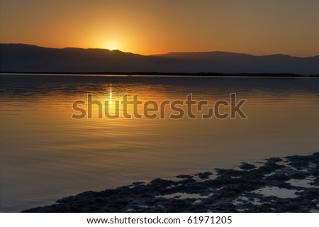 Dead Sea at dawn and the first ray of sun that has risen over the Jordanian mountains.