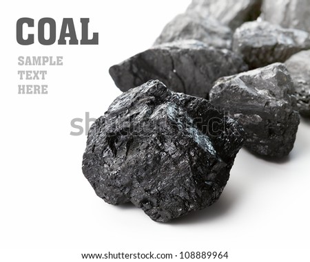 Coal lumps spilled on white background with copy space