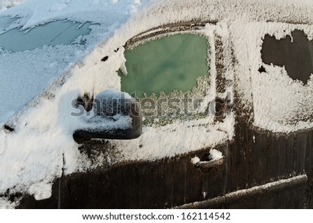 The car in the snow outside in a winter season.