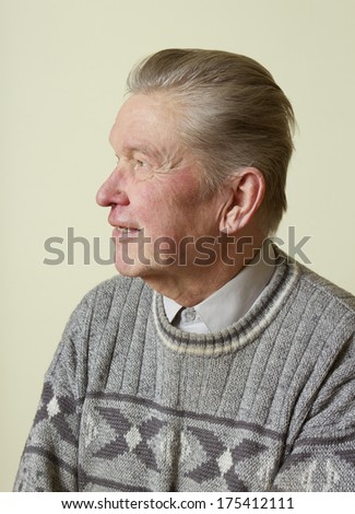Man in a home wearing warm clothe.