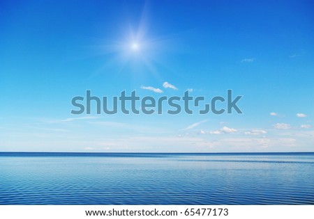 Sun on the blue sky above sea.