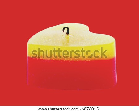 To burn out yellow -red candle on the red background.