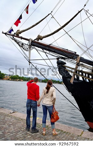 Man and woman at the old ship on Stockholm pier.