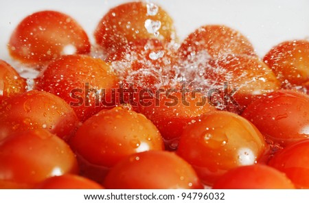 Red tomatoes and water splash.