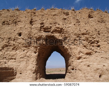 old city wall with open gate towards the desert, Gansu, China