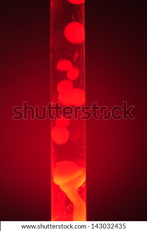 Red lava lamp at night. Studio shot, isolated in darkness