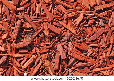 Close up on a pile of chopped wood background, red wood pieces for flower bed