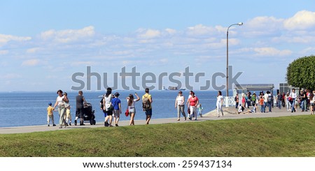 PETRODVORETS, RUSSIA, CIRCA 2014 - The tourists on the pier of the Baltic seaside circa 2014 in Petrodvorets, Russia