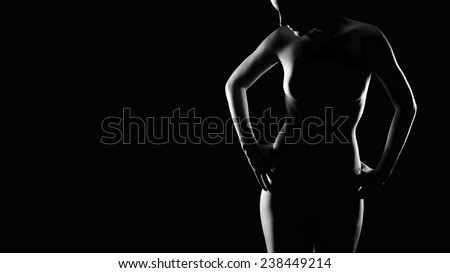 Erotic contour of an attractive young woman, decent nude without visible private parts, monochrome photo with copy space on the left side