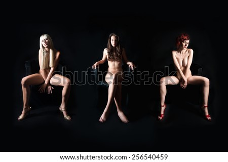 Three attractive nude models in front of dark studio background, their private parts are not visible