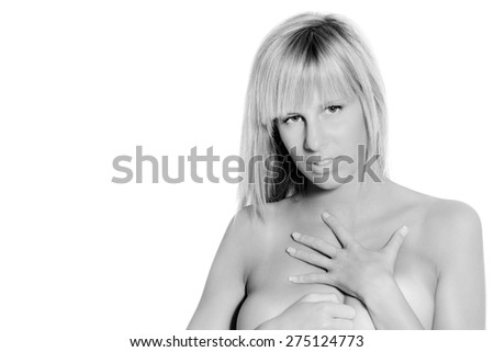 Closeup portrait of a beautiful nude blond woman covering herself, beauty concept in front of white studio background, monochrome photo with copy space on the left side of the image