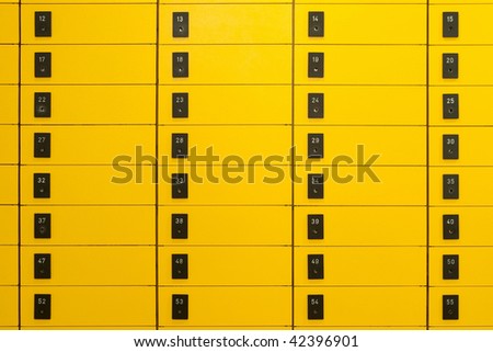 Yellow post office boxes with numbering on black signs